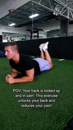 a man laying on the ground with his feet up in front of him while doing push ups