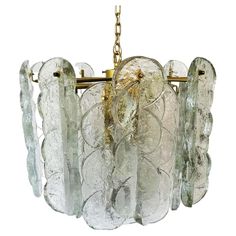 a glass chandelier hanging from a chain