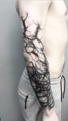 a man's arm is covered in black ink