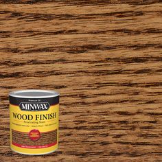 a can of wood finish sitting on top of a wooden table