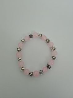 Glass beaded bracelet- Pale pink beads. 12 glass beads and 12 flower beads long. 7 inches long. Elastic stretchy band. The perfect piece for your jewelry collection. Adjustable Pink Flower Charm Bracelet, Pink Crystal Bracelet With Large Beads For Gift, Pink Crystal Bracelet With Large Beads As Gift, Pink Flower Charm Bracelet For Jewelry Making, Spiritual Pink Beaded Bracelets With Large Beads, Beaded Stretch Flower Bracelet, Pink Stretch Bracelet With Spacer Beads As Gift, Pink Beaded Flower Charm Bracelet, Pink Flower-shaped Beaded Charm Bracelet