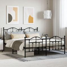 a bedroom with white walls and black metal bed frame