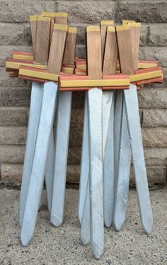 several knives are stacked on top of each other in front of a brick wall,