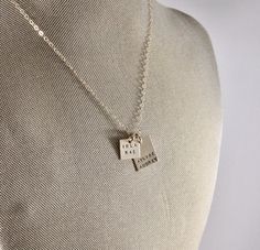 Gold Names Square and Rectangle Necklace Two matte 14k gold-filled tags on a gold chain. The square half an inch, and can fit up to three names (7 letters or less each). The rectangle is 3/4" long and is stamped with up to three names, also 7 letters or less. Mom Jewelry Personalized, Necklace With Name, Rectangle Necklace, Hoop Charms, Gold Filled Necklace, Layered Chains, Gold Charm Necklace, Mom Jewelry, Cute Charms