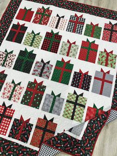 a quilted table runner with christmas presents on it