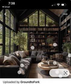 a living room filled with lots of furniture and bookshelves next to a window