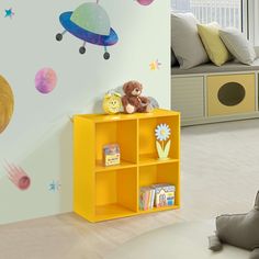 a child's room with a yellow bookcase and space themed wall decals