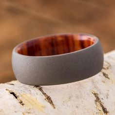 a wooden ring sitting on top of a piece of wood