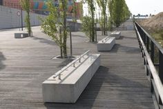 concrete benches lined up on a wooden deck