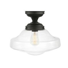 a light fixture with a clear glass shade on the top and an black metal base