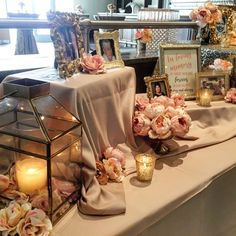 a table with flowers and candles on it