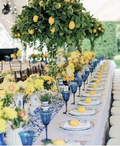 an image of a table setting with lemons and blue glassware on the table