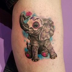 an elephant tattoo on the thigh