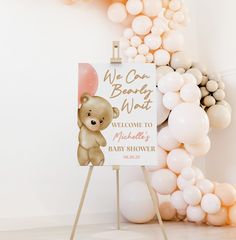 there is a sign that says welcome to baby shower with balloons in the shape of a bear