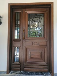 an ornate wooden door with glass panels