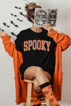 Spooky T-Shirt, Halloween T-Shirt, Cute Ghost Shirt, Cute Fall Shirts, Spooky Season Shirt, Orange Spooky Shirts, Retro Spooky Shirts Gildan 5000 - Heavyweight Cotton T-Shirt Features (G500): Made from 100% preshrunk cotton, the fabric of this t-shirt is highly breathable, is friendly to skin and doesn't shrink after washing. It has a seamless ribbed round neck collar with shoulder to shoulder taping on the inside to give a well-structured look to your shoulders. There is double stitching on the Spooky Crew Neck Shirt With Letter Print, Spooky Short Sleeve Shirt With Letter Print, Spooky Orange Crew Neck T-shirt, Spooky Halloween Shirt With Letter Print, Spooky Shirts, Cute Fall Shirts, Ghost Shirt, Halloween T Shirt, Cute Ghost