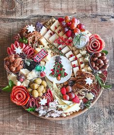 an assortment of cheeses and nuts arranged on a platter