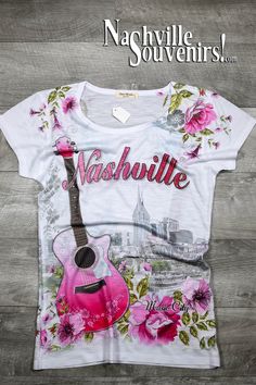 A very soft and pretty Women's Nashville Shirt with Floral Guitar and Skyline printed in bright pink and gray designs. Features downtown Nashville skyline with an acoustic guitar.   Get yours today with FREE SHIPPING on all US orders over $50! Nashville Gift Ideas, Nashville Shirts, Floral Guitar, Opryland Hotel, Angela Rose, Nashville Skyline, Souvenir Ideas, Downtown Nashville, Road Trippin