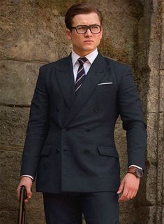 Everybody wants to enhance their overall personality by wearing replicas of their favorite star's clothing, here is one - a replica of a blue suit worn by Taron Egerton during his 2014 action spy comedy film "Kingsman: The Secret Service" while playing the role of Gary 'Eggsy' Unwin. Providing you a modern look and confident demeanor, our Kingsman Double Breasted Blue Wool Suit will surely be an extension of yourself and will drape like a second skin over your body.  The Double-Breasted suit wil Daper Man, Kingsman Suits, Film Kingsman, Double Breasted Suit Men, Kingsman The Secret Service, Stylish Mens Suits, Blue Suit Men, Classy Suits, Star Clothing