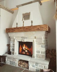 a fire place with logs stacked around it