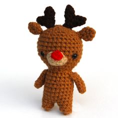 a crocheted stuffed animal with a red nose and antlers on it's head