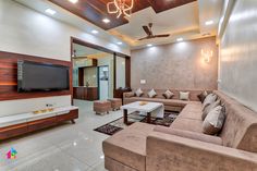 a living room with two couches and a flat screen tv mounted on the wall