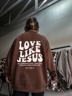 Christian Crewneck, Love Like Jesus Sweatshirt, Bible verse shirt, Christian merch, Christian streetwear, Faith based shirt, Jesus sweater T-shirt version: https://www.etsy.com/LovePeopleBoutique/listing/1342450563/love-like-jesus-christian-shirt?utm_source=Copy&utm_medium=ListingManager&utm_campaign=Share&utm_term=so.lmsm&share_time=1676326374500 These are UNISEX Sweatshirts so run like Men's. However, your typical size will usually work best, as they are meant to fit a touch loose. Please make Jesus Sweater, Christian Clothing Brand, Christian Crewneck, Jesus Clothes, Christian Shirts Designs, Christian Merch, Christian Streetwear, Jesus Sweatshirts, Love Like Jesus