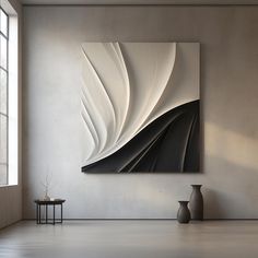 an abstract painting hangs on the wall next to two vases and a small table