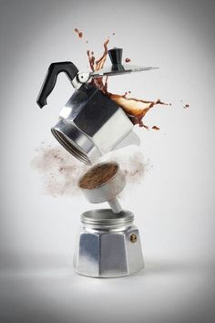 a coffee pot is being thrown into the air with a knife sticking out of it