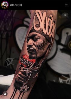 a man's arm with a tattoo on it that has the image of a rapper