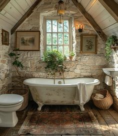 an old fashioned bathtub and toilet in a rustic bathroom with stone walls, exposed beams and wood flooring