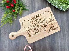 a cutting board with the words treats for santa written on it