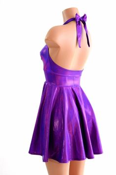 "This item is made to order, please read all the way through the listing before purchasing! This flowy dress is made of beautiful grape purple holographic spandex. The halter top is darted and ties behind the neck, the hemline is circle cut. Length: 17\" measured from the waist to the hemline. We can create this dress from any other fabric in our shop, just ask! Womens Sizing (See below for instructions on where measurements should be taken) XXS: Bust 29\"-30\" / Waist 22\"-23\" / Hips 30\"-32\" Metallic Fitted Halter Neck Dress, Fitted Iridescent Mini Dress For Spring, Spring Fitted Iridescent Mini Dress, Iridescent Fitted Mini Dress, Spring Iridescent Fitted Mini Dress, Fitted Rave Party Dresses, Summer Party Purple Halter Dress, Iridescent Fitted Spring Dress, Purple Stretch Halter Neck Dress