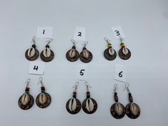 Coconut Shell earrings that come with Rasta beads on top. Available in white or brown cowrie shells. White Shell-shaped Cowrie Shell Earrings, White Cowrie Shell Earrings, Brown Dangle Jewelry For Vacation, Traditional Brown Jewelry For Summer, Summer Traditional Brown Jewelry, Handmade Brown Cowrie Shell Jewelry, Brown Beaded Drop Earrings For Beach, Handmade Brown Beaded Earrings For Beach, Handmade Brown Earrings For Beach