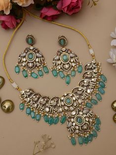 Adorn yourself in regal elegance with this premium Sabyasachi-inspired Polki Victorian necklace set. Meticulously crafted, the intricate design captures the essence of Indian bridal opulence. Embellished with turquoise and firozi accents, this piece is a stunning tribute to timeless Pakistani jewelry, making you the epitome of grace and sophistication. Elevate your bridal ensemble with this resplendent creation. Item contains: Necklace and earrings . Highest quality and craftsmanship Necklace Fitting is adjustable Necklace length 18 inches with an adjustable chain at the back Earrings length 2.5 inches Each earring weighs 20 gms ( light weight) Earrings closure: Pushback  Item is ready to be shipped from New Delhi, India Turquoise Indian Jewelry, Elegant Turquoise Wedding Sets, Turquoise Kundan Necklace With Meenakari For Wedding, Turquoise Kundan Bridal Necklace For Festive Occasion, Sabyasachi Jewellery Earrings, Festive Turquoise Kundan Bridal Necklace, Sabyasachi Choker Necklace, Elegant Turquoise Kundan Necklace, Sabyasachi Jewellery Choker