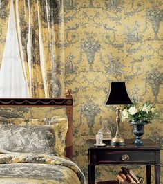 a bedroom with yellow wallpaper and curtains