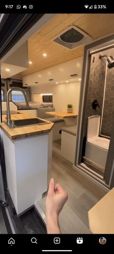 a person is taking a photo of the inside of a camper with their cell phone