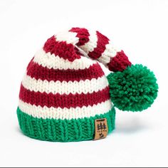 a red, white and green striped knitted hat with pom - pom