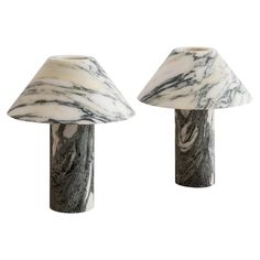 two marbled lamps are sitting next to each other