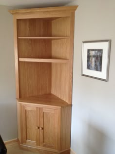 a wooden bookcase sitting in the corner of a room