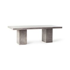 a concrete table sitting on top of a white floor