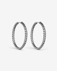 two pairs of hoop earrings with silver chains on each side and an oval design in the middle