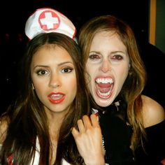 two young women dressed up as nurses posing for the camera with their mouths wide open