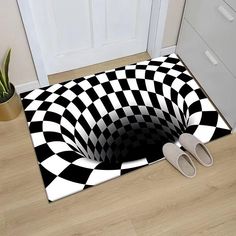 a black and white checkered floor mat with slippers on the floor next to it