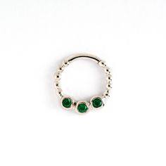 Beautiful and feminine sterling silver tiny septum with carved dots around it circumference, ornamented with three high quality polished Green Onyx gemstones. Can fit also as an earrings / Helix / conch / cartilage / tragus piercing. This design available also with White Topaz gemstone, Black Onyx, Garnet and Ruby, check it out on the septum section. Material: 925 Sterling Silver Green Onyx gemstone Dimensions: Diameter - 8 mm Thickness - 1.2 mm (16g) All of our jewellery packed in our labeled g Elegant Adjustable Nickel-free Septum Ring, Elegant Hypoallergenic Sterling Silver Septum Ring, Bijoux Piercing Septum, Cute Septum Rings, Silver Septum Ring, Septum Piercing Jewelry, Drippy Fits, Septum Nose Rings, Septum Rings