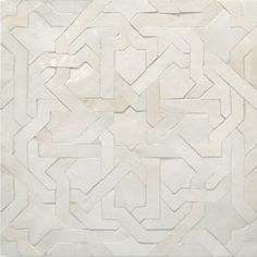 a white tile with an intricate design on the top and bottom part of it's surface