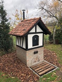 an outdoor oven made out of wood and brick