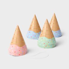 four party hats with sprinkles on them