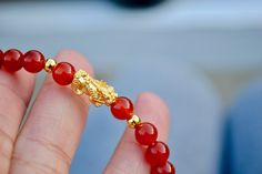 "This is Pure Real 24 Karat Gold Pixiu/Natural Carnelian Gold Pixiu Piyao( less than 1 g ) - Approximately 13mm x 6mm 14 karat Gold Beads Round - Approximately 3mm Carnelian Beads - Approximately 6mm Hallmark/Stamp 999 for 24k Gold (PIXIU) Please select bracelet size. All are handmade with care .Strung on heavy duty stretchy/elastic. Products and photo may differ. Bracelet Comes with Storage Bag & Box How to Determine Bracelet Size: Step 1: Measure your wrist just below the wrist bone, where Red Carnelian Beaded Bracelets For Gift, Red Carnelian Bracelets As Gift, Red Carnelian Bracelets As A Gift, Red Carnelian Bracelets For Gifts, Gold Red Coral Bracelets As Gift, Gold Red Coral Bracelet As A Gift, Gold Bracelets With Red Coral As Gift, Gold Red Coral Bracelets For Gifts, Gold Red Coral Bracelet For Gift