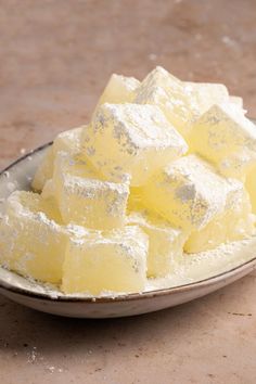 a bowl filled with sugar cubes on top of a table